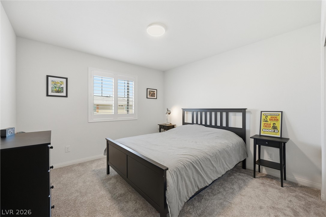 3705 Alla Rocca Avenue Henderson, NV 89044 - Photo 27 of 50 This serene bedroom #4 offers comfortable carpeting and natural light through elegant window shutters.