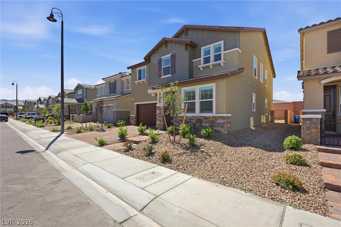 3705 Alla Rocca Avenue Henderson, NV 89044 - Photo 3 of 50 This modern home features charming shutters, an attached garage, and a welcoming sidewalk.
