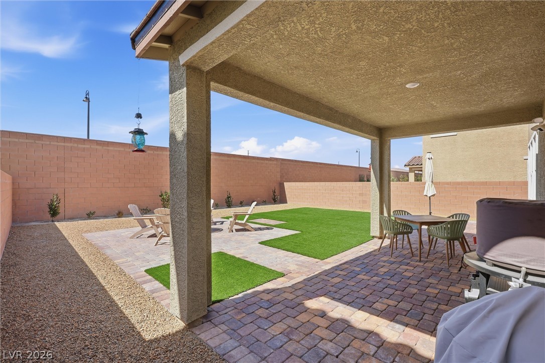 3705 Alla Rocca Avenue Henderson, NV 89044 - Photo 35 of 50 Enjoy outdoor living with this inviting covered patio and lush green space.