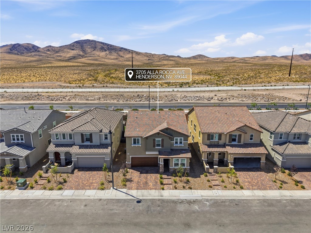 3705 Alla Rocca Avenue Henderson, NV 89044 - Photo 39 of 50 An aerial view captures the home's impressive facade with a mountain backdrop.