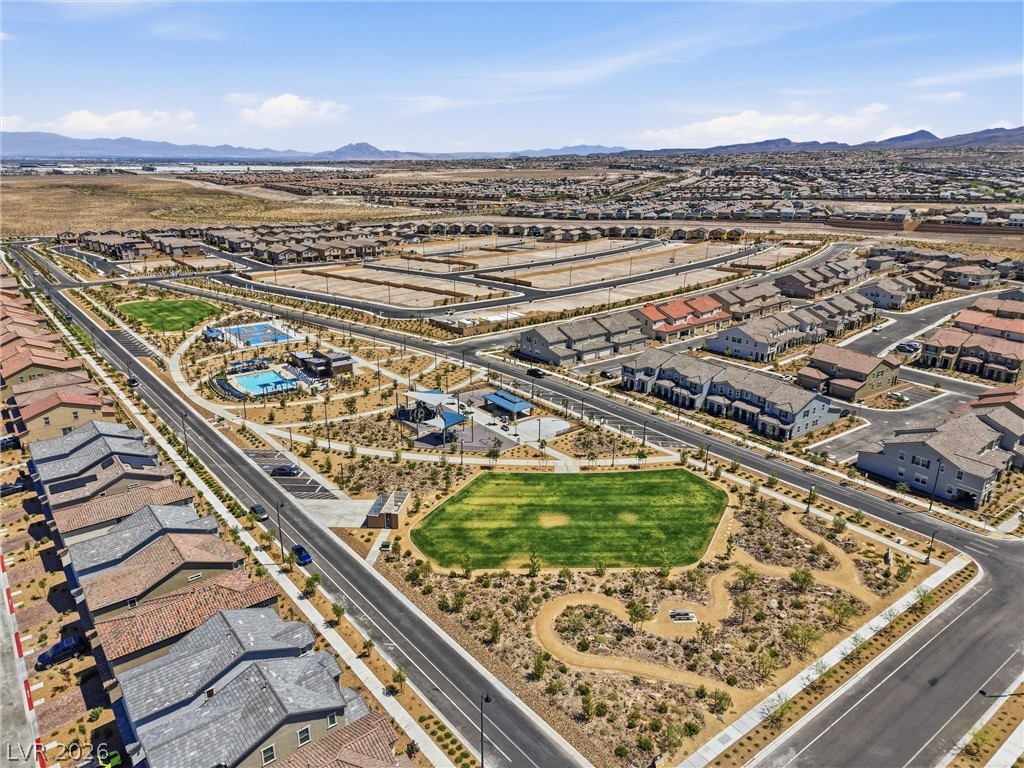 3705 Alla Rocca Avenue Henderson, NV 89044 - Photo 45 of 50 An aerial view captures a vibrant community with houses, parks, and recreational amenities under a clear sky.