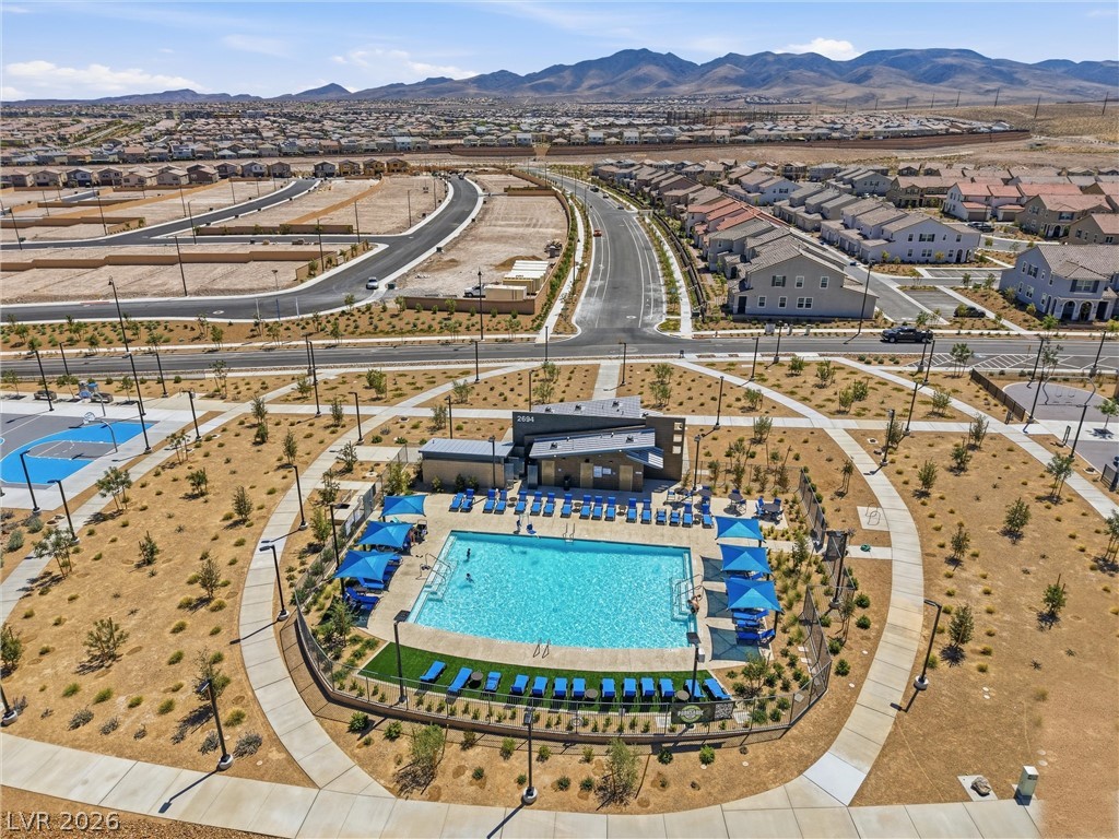 3705 Alla Rocca Avenue Henderson, NV 89044 - Photo 46 of 50 This aerial view showcases a vibrant community pool area surrounded by scenic desert landscaping and mountain vistas.