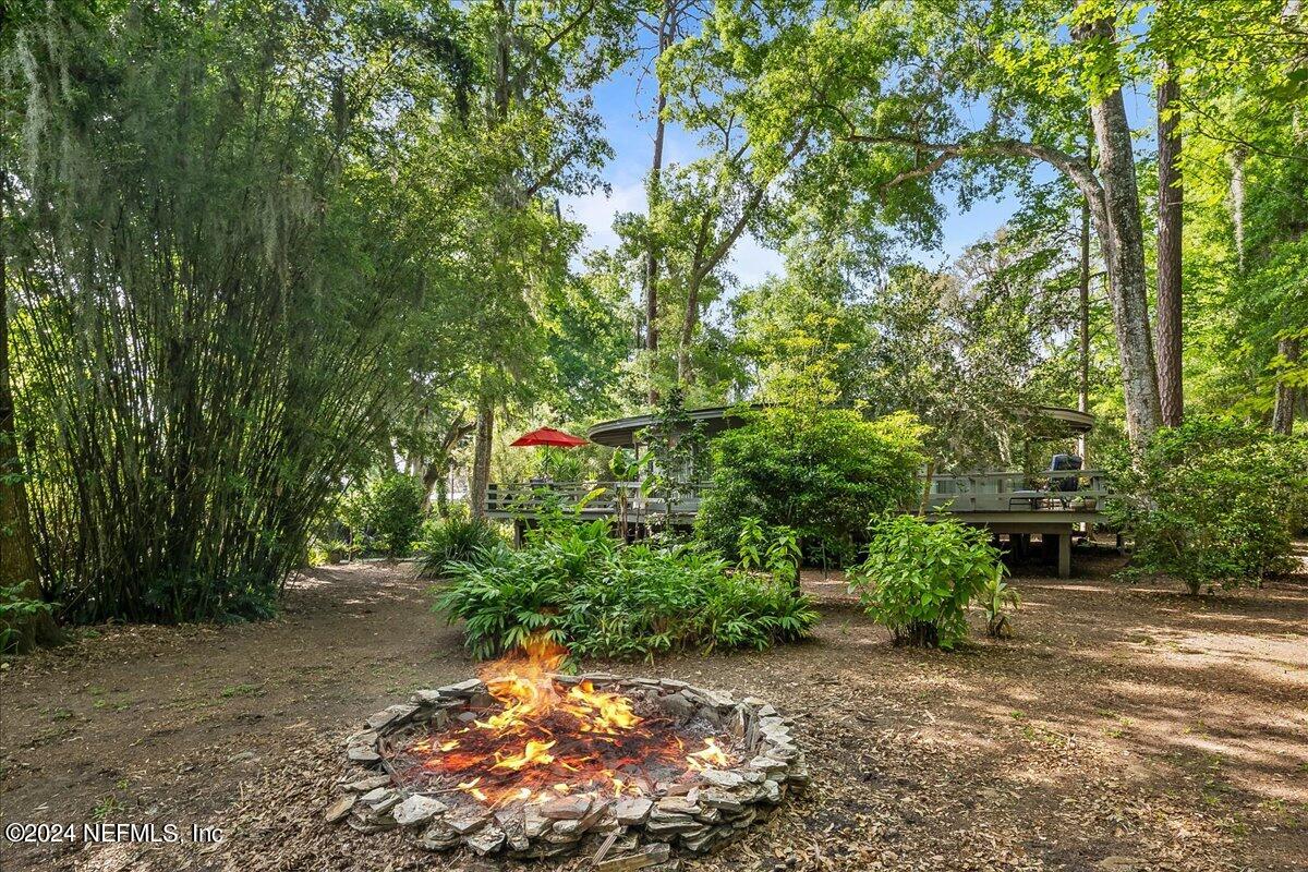 97575 Pirates Point Road Yulee, FL 32097 - Photo 15 of 22 a backyard of a house with lots of green space