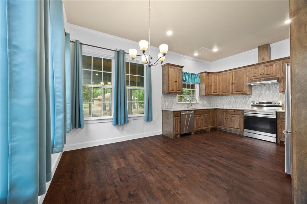 2526 Fox Point Circle Quinlan, TX 75474 - Photo 13 of 35 Spacious dining room opens onto gorgeous kitchen