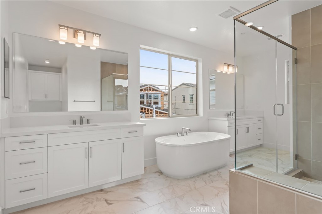 5208 Solace Drive Rancho Mission Viejo, CA 92694 - Photo 14 of 27 a spacious bathroom with a double vanity sink mirror and double