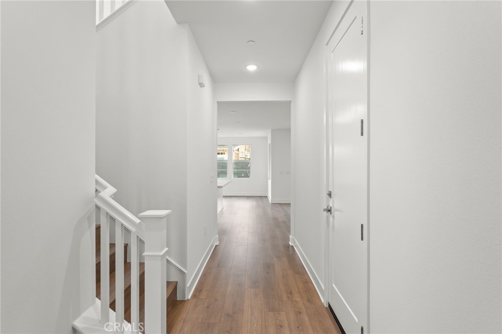 5208 Solace Drive Rancho Mission Viejo, CA 92694 - Photo 5 of 27 a view of a hallway with wooden floor and staircase