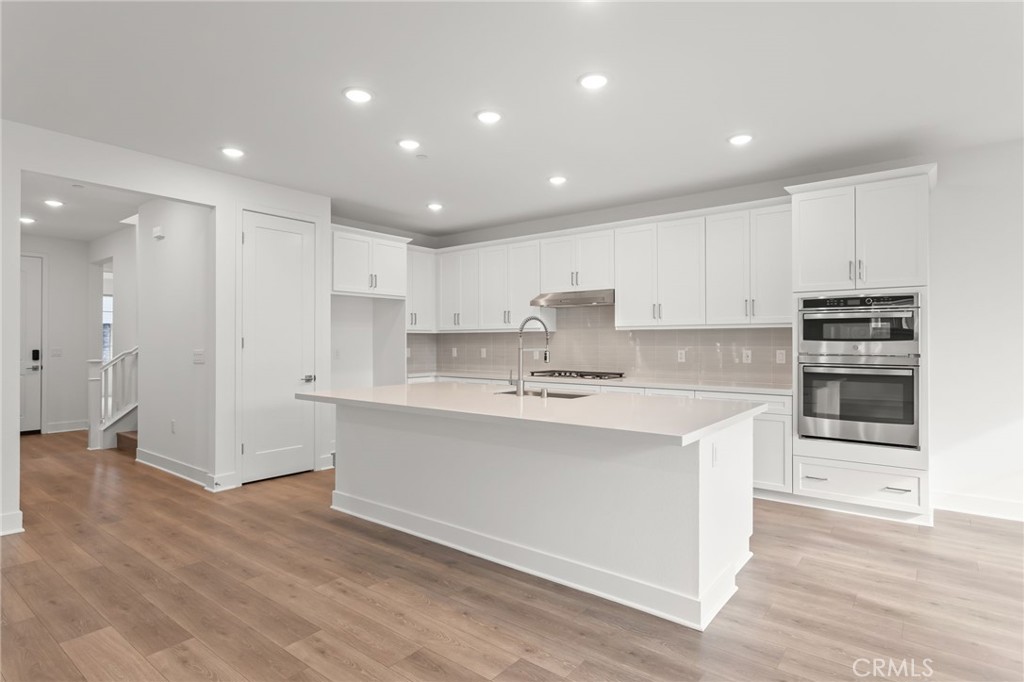 5208 Solace Drive Rancho Mission Viejo, CA 92694 - Photo 8 of 27 a kitchen with stainless steel appliances a refrigerator sink and cabinets