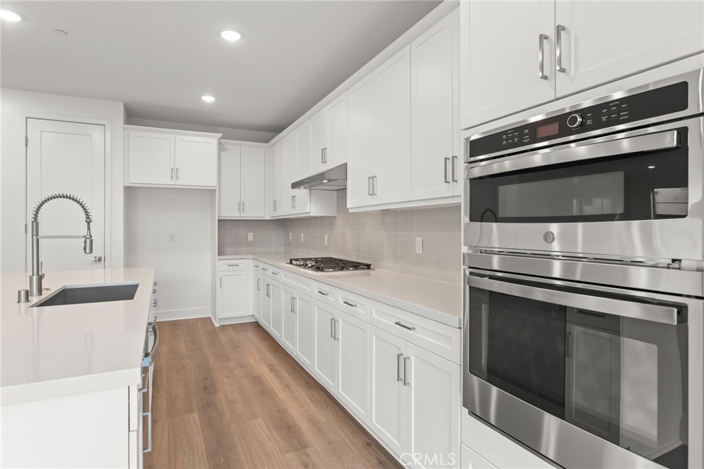 5208 Solace Drive Rancho Mission Viejo, CA 92694 - Photo 9 of 27 a kitchen with stainless steel appliances kitchen island granite countertop a stove sink and cabinets