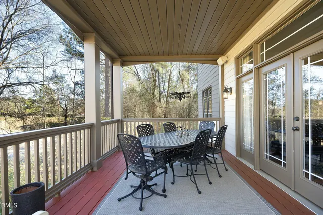 a large kitchen with granite countertop a refrigerator a sink a stove and white cabinets