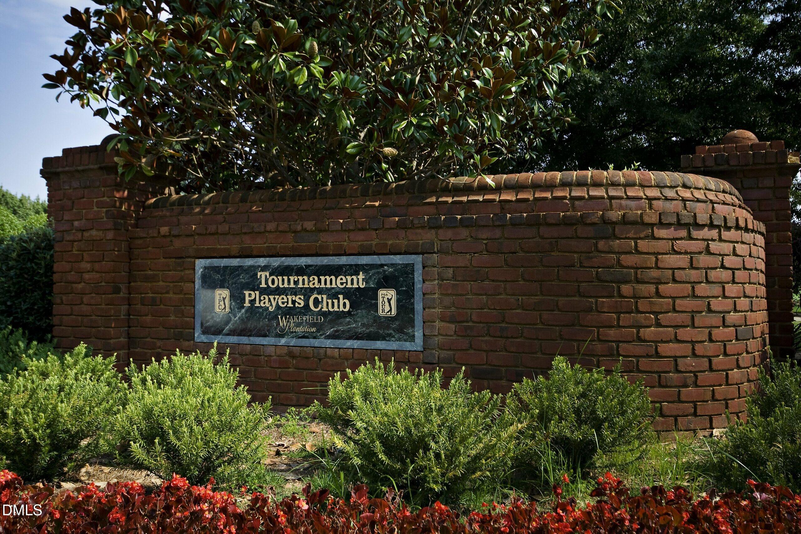 2705 Peachleaf Street Raleigh, NC 27614 - Photo 48 of 52 a sign that is sitting in front of flowers