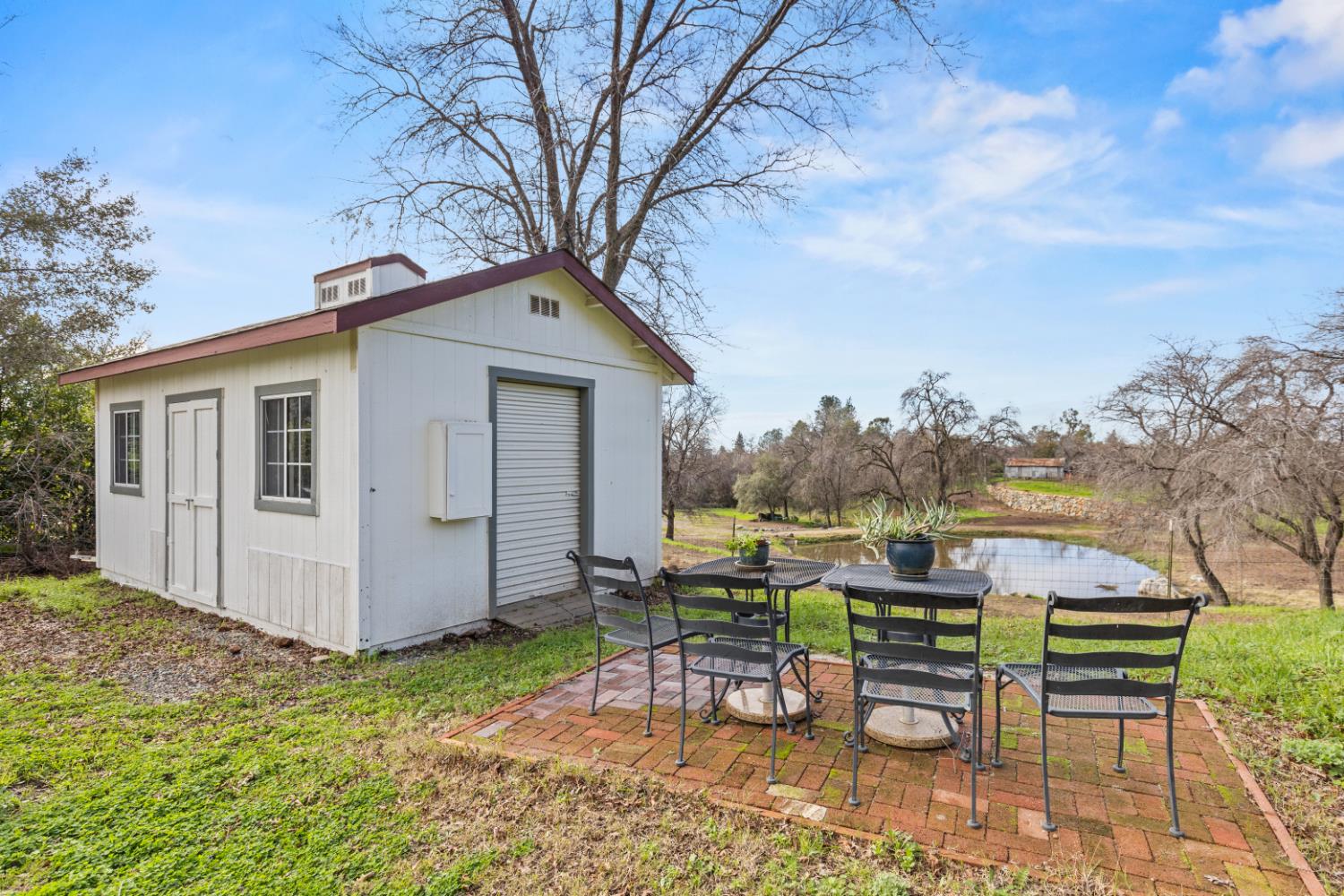 4287 Burnett Road Lincoln, CA 95648 - Photo 50 of 63 Storage shed with roll up door overlooking the adjacent pond and vineyard.