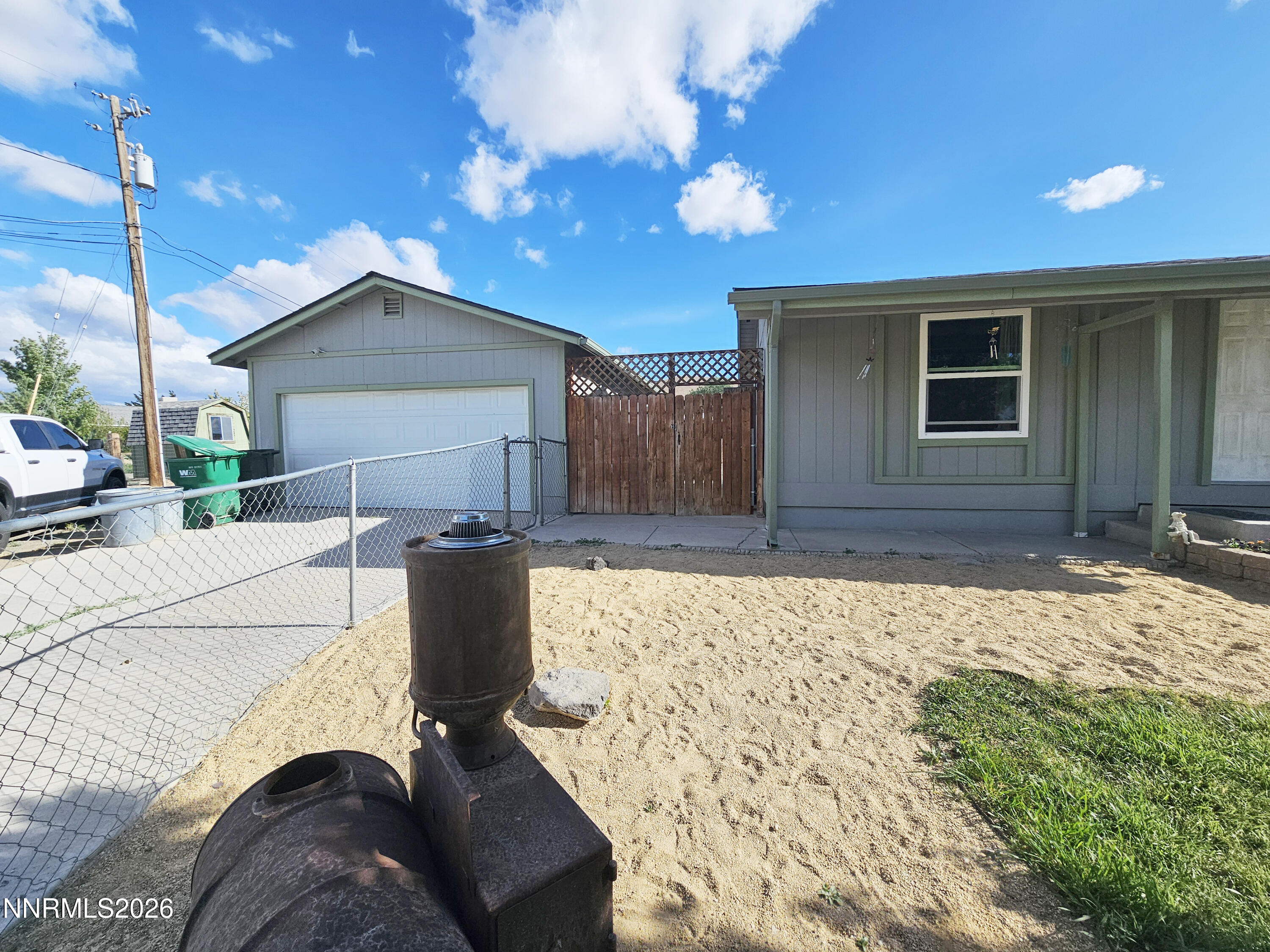 1125 Rancho Road Fernley, NV 89408 - Photo 6 of 47 a view of backyard with a barbeque grill and potted plants
