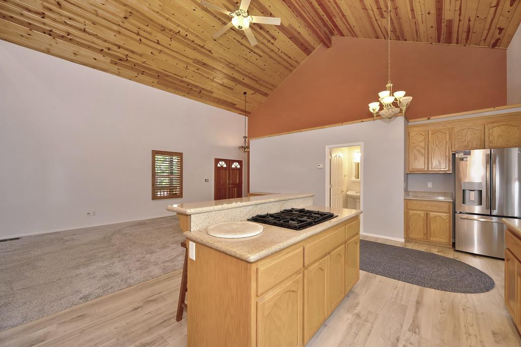 1861 Rubicon Road Georgetown, CA 95634 - Photo 21 of 68 a kitchen with stainless steel appliances granite countertop a stove a sink dishwasher and a refrigerator with wooden floor