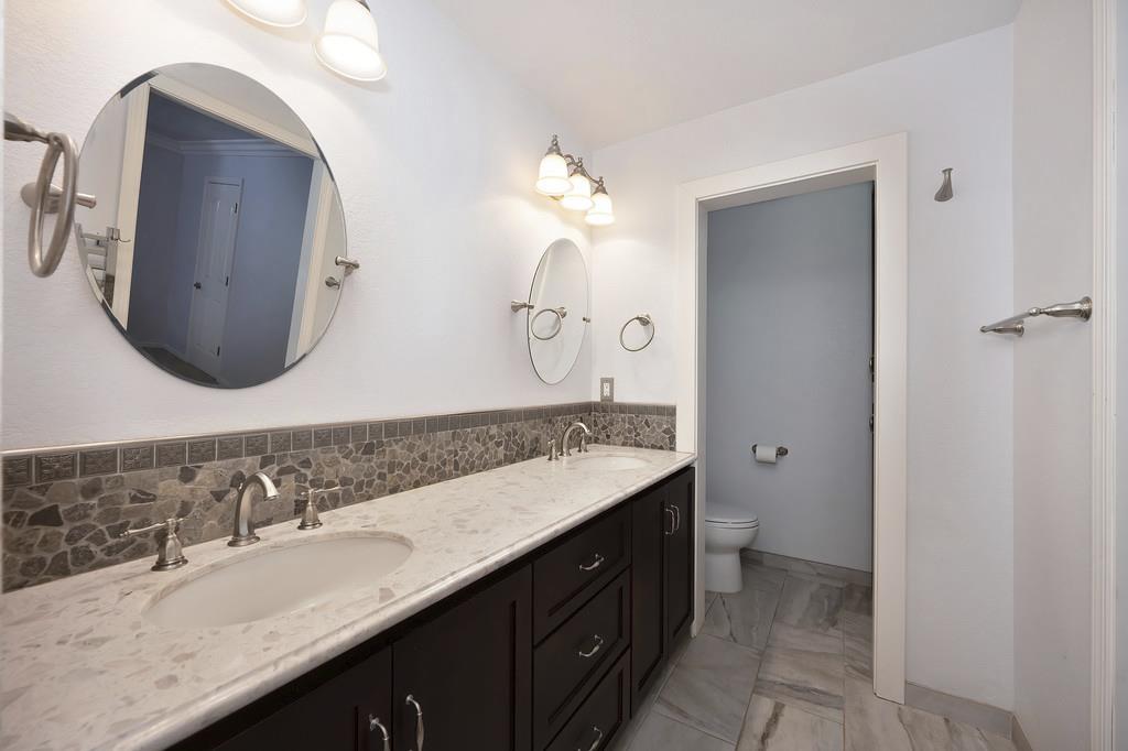 1861 Rubicon Road Georgetown, CA 95634 - Photo 32 of 68 a bathroom with a double vanity sink and a mirror