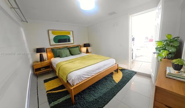 a bedroom with a bed and a potted plant