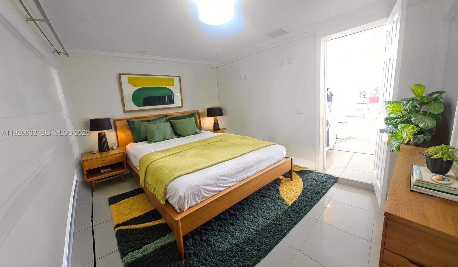 1071 West 66th Street Hialeah, FL 33012 - Photo 11 of 17 a bedroom with a bed and a potted plant