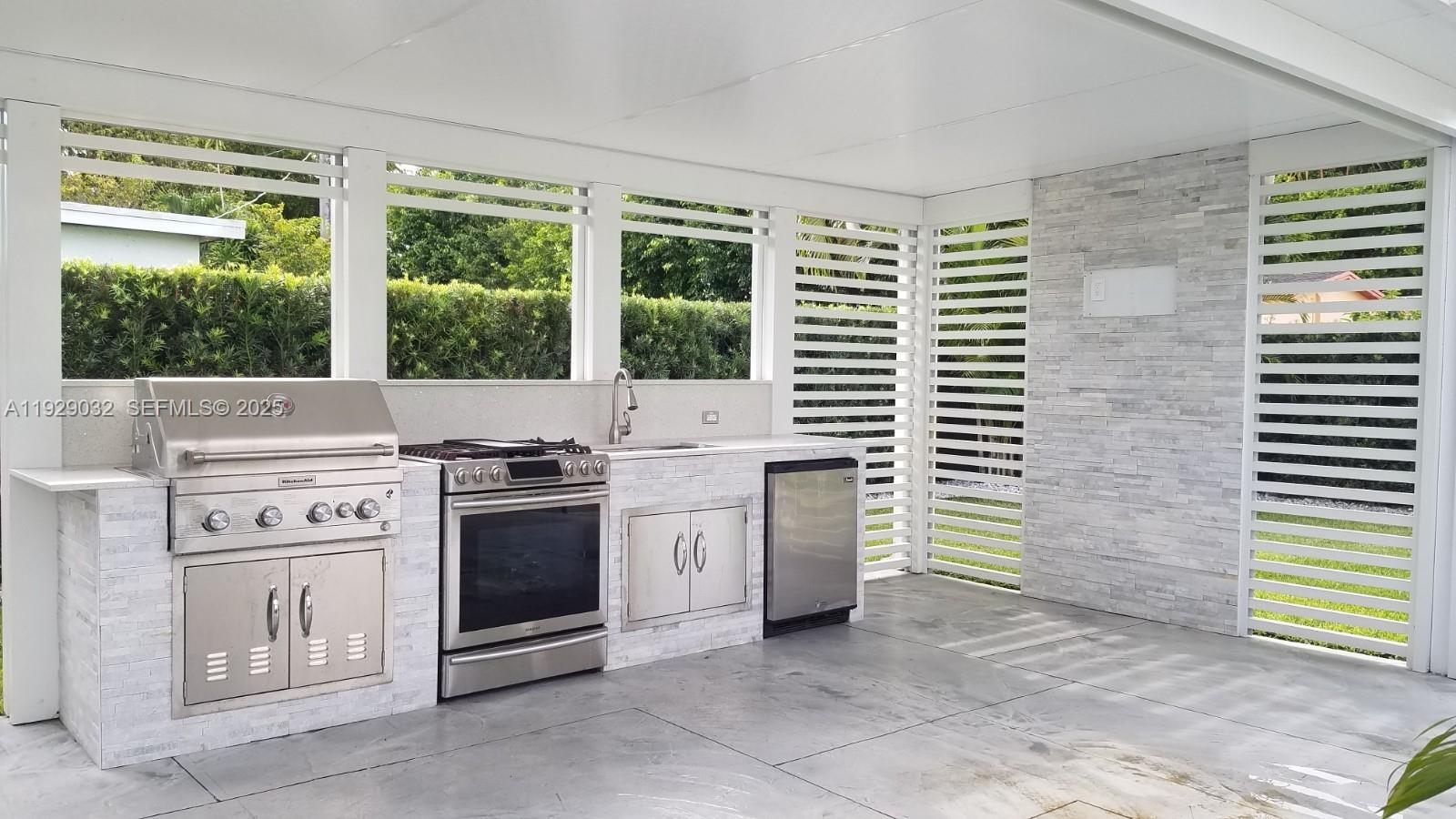 1071 West 66th Street Hialeah, FL 33012 - Photo 14 of 17 a view of a kitchen with a stove top oven