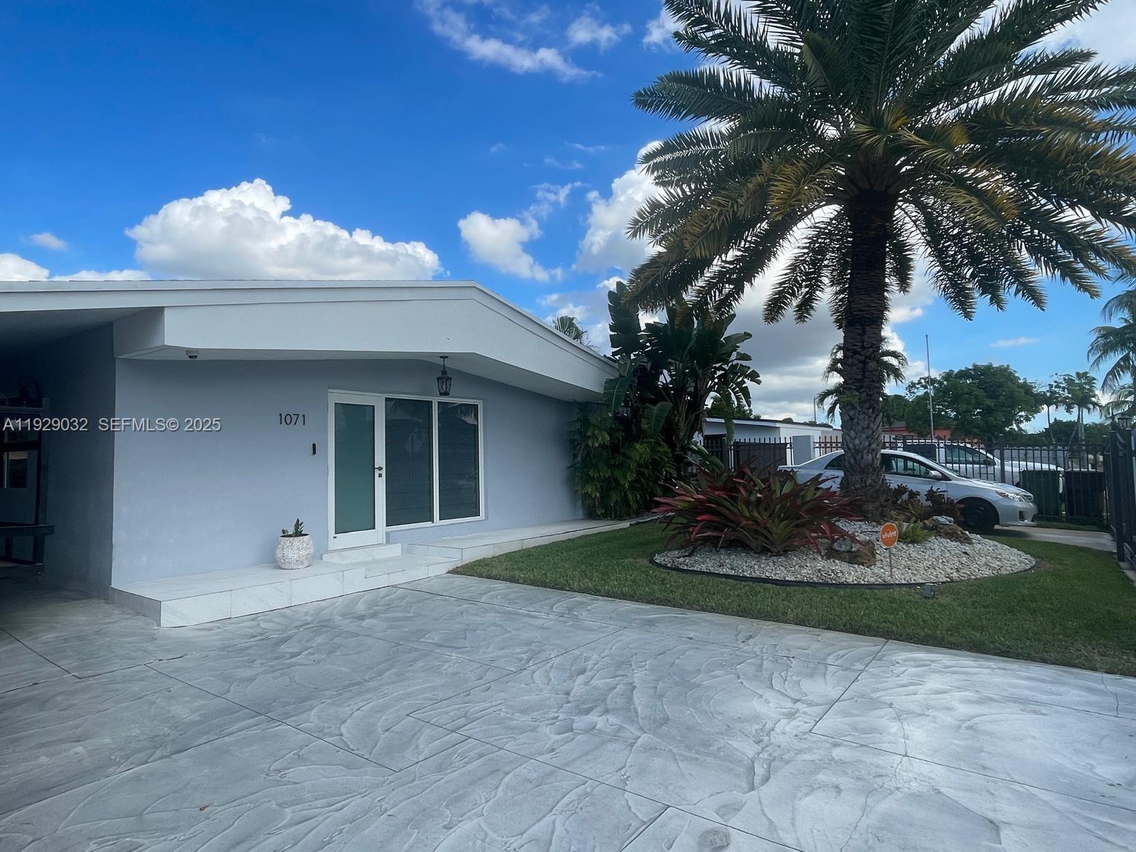 1071 West 66th Street Hialeah, FL 33012 - Photo 4 of 17 a front view of a house with garden