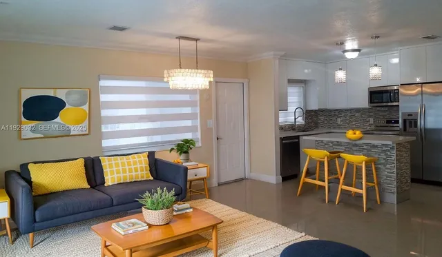 a living room with furniture and kitchen view