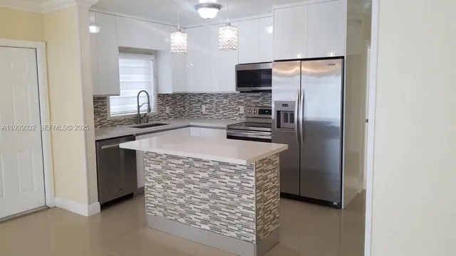 a kitchen with stainless steel appliances a refrigerator and a sink
