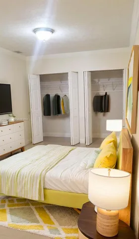 a bedroom with a bed and couch