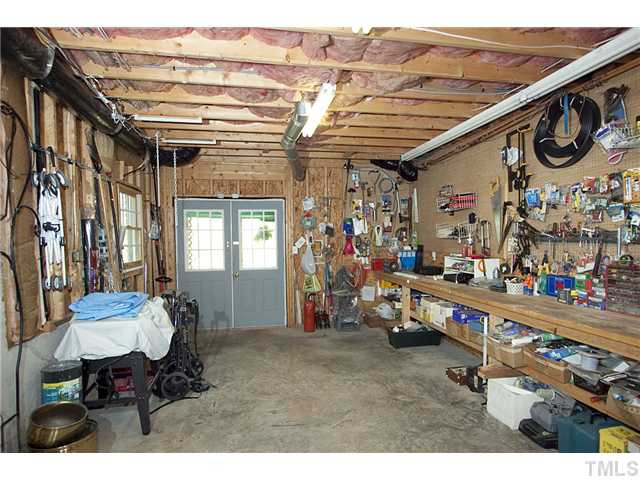 4716 Salem Ridge Road Holly Springs, NC 27540 - Photo 24 of 25 Large workshop and over 1000 sq.ft of storage space. Plus a concrete basement foundation and space for a wine cellar Workshop