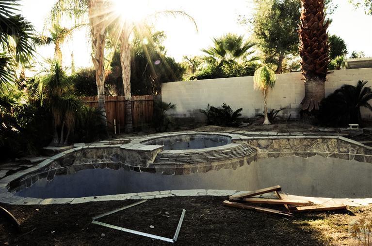 72955 Somera Road Palm Desert, CA 92260 - Photo 4 of 16 a view of a swimming pool with a yard