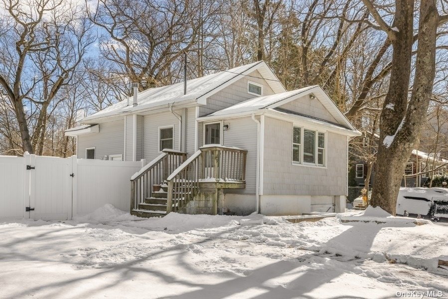 a view of a house with snow on the road