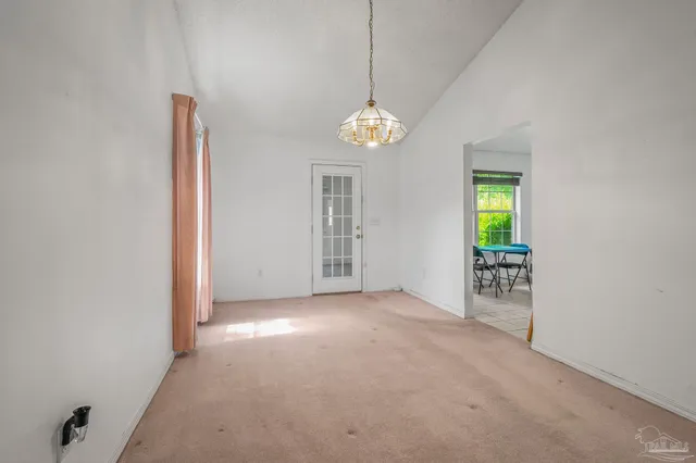 an empty room with windows and entrance