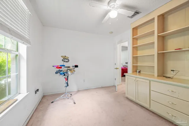 a kitchen with a sink a stove cabinets and a window