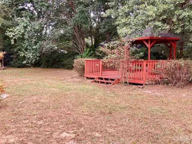 a front view of a house with yard and sitting area