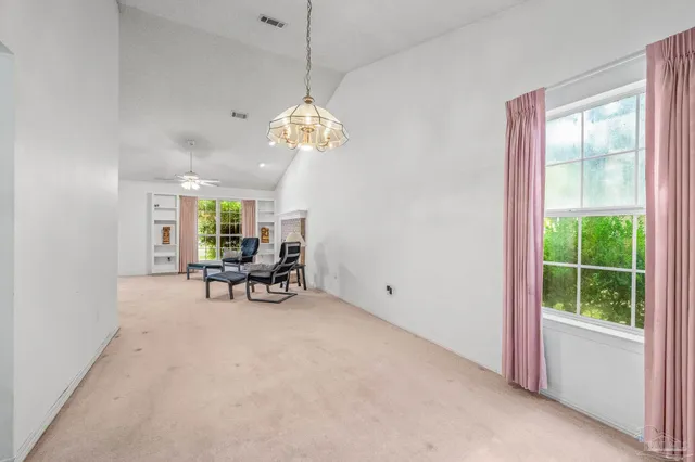 a view of a livingroom with a furniture window and outside view