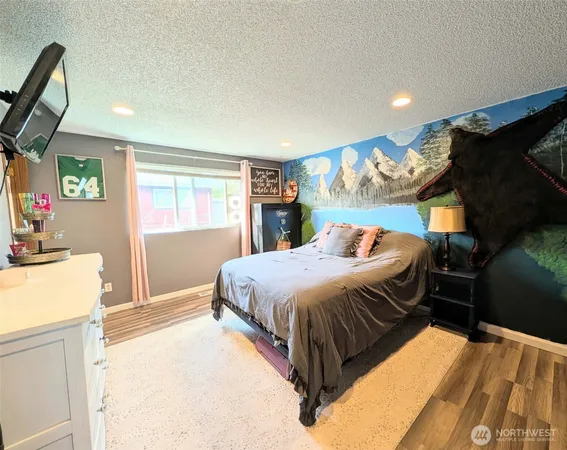a bed sitting in a bedroom next to a window