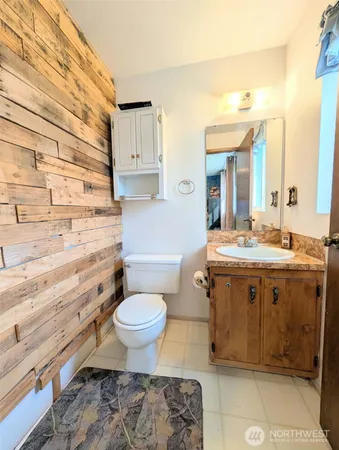 a bathroom with a sink toilet a mirror and vanity