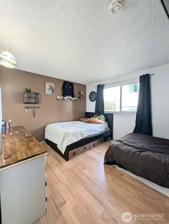 a bedroom with two beds and a dresser