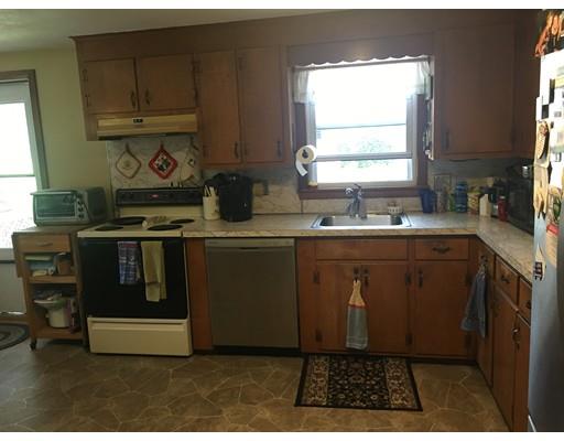 44 Colorado Street Springfield, MA 01118 - Photo 11 of 12 a kitchen with stainless steel appliances granite countertop a stove a sink and a microwave