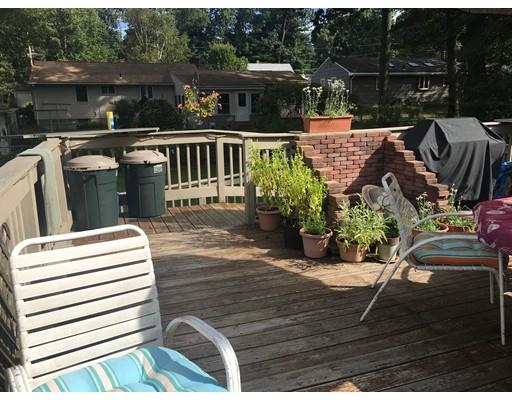 44 Colorado Street Springfield, MA 01118 - Photo 4 of 12 a balcony with wooden floor table and chairs