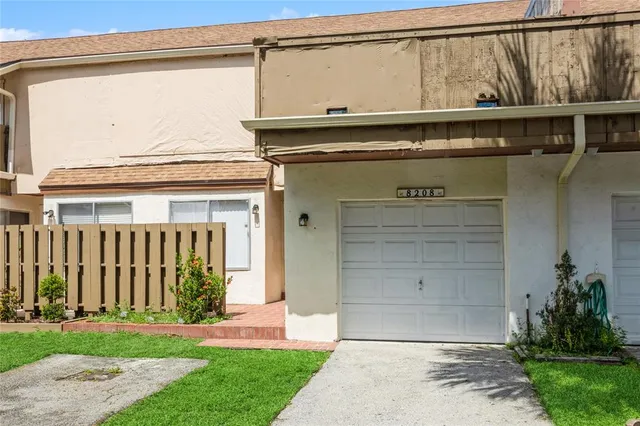 a front view of a house with a yard and a garage