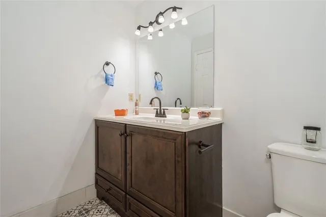 a bathroom with a sink vanity and a mirror