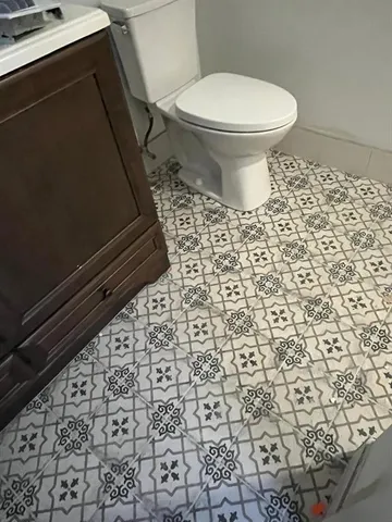 a bathroom with a toilet and a shower curtain