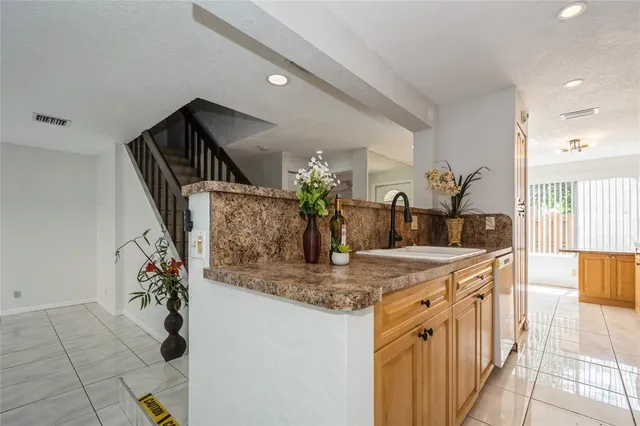 a kitchen with sink and refrigerator