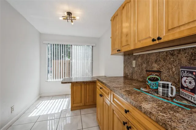 a kitchen with granite countertop a sink a stove and cabinets