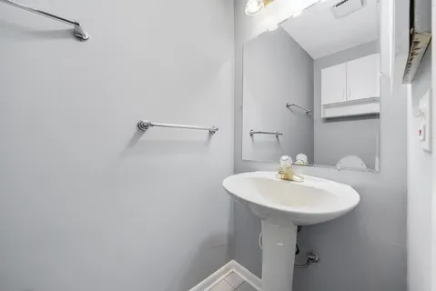 a bathroom with a sink a mirror and a toilet