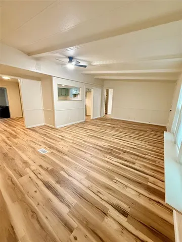 a room with a bed and view of living room