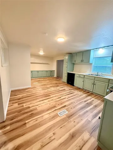 a kitchen with stainless steel appliances kitchen island granite countertop a sink stove and cabinets