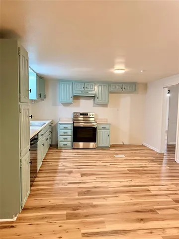 a kitchen with granite countertop a sink and cabinets