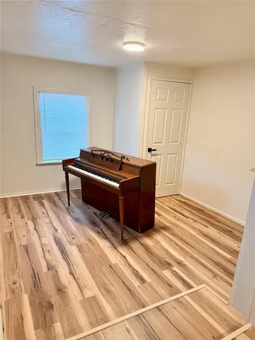 a view of a livingroom with wooden floor and a sink