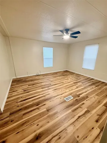 a view of a bedroom with a bed and a chandelier
