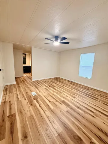 a bedroom with a bed and mirror