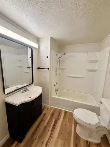 a bathroom with a sink toilet and mirror